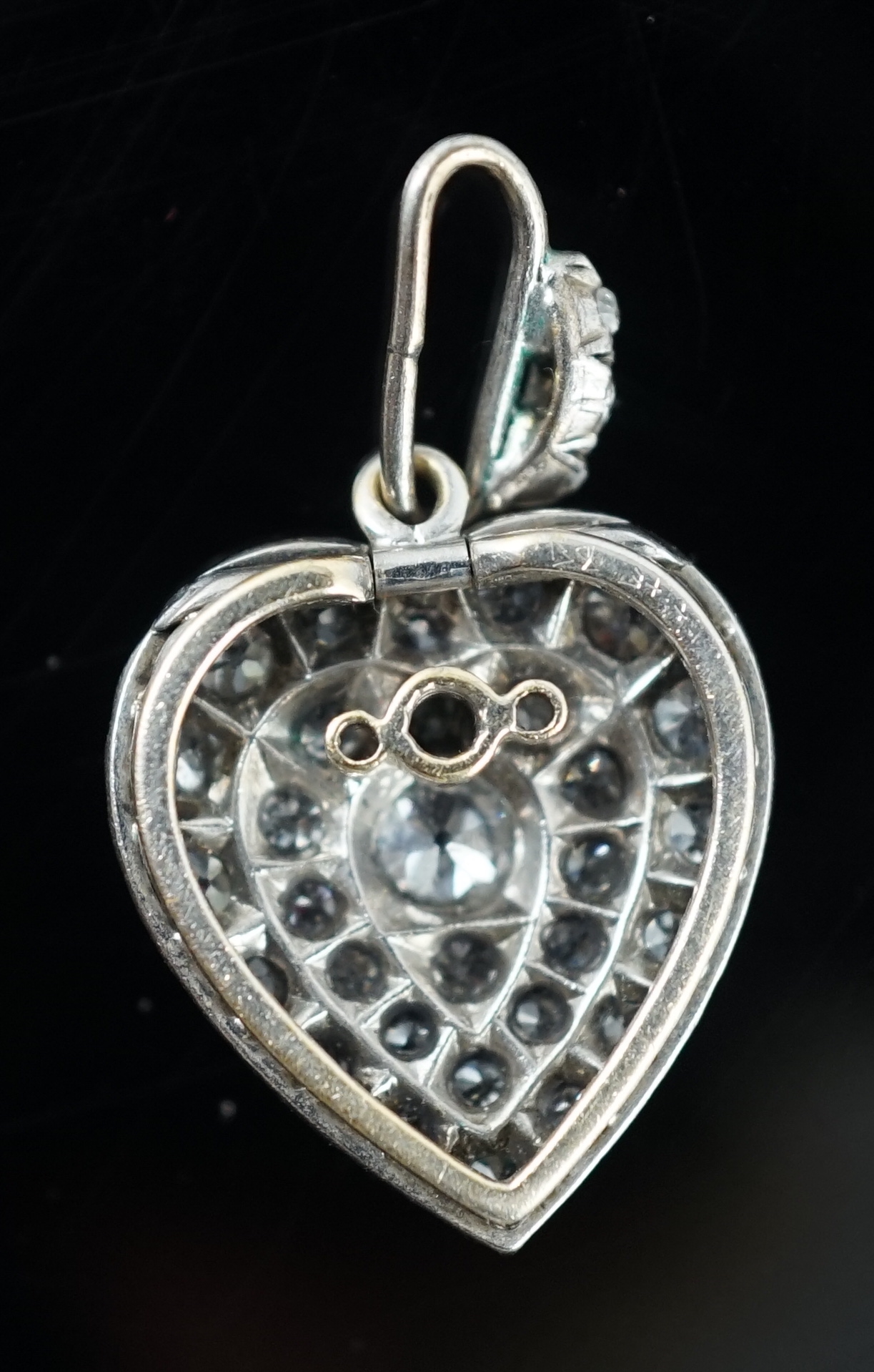 An early 20th century white gold and pave set diamond heart shaped pendant